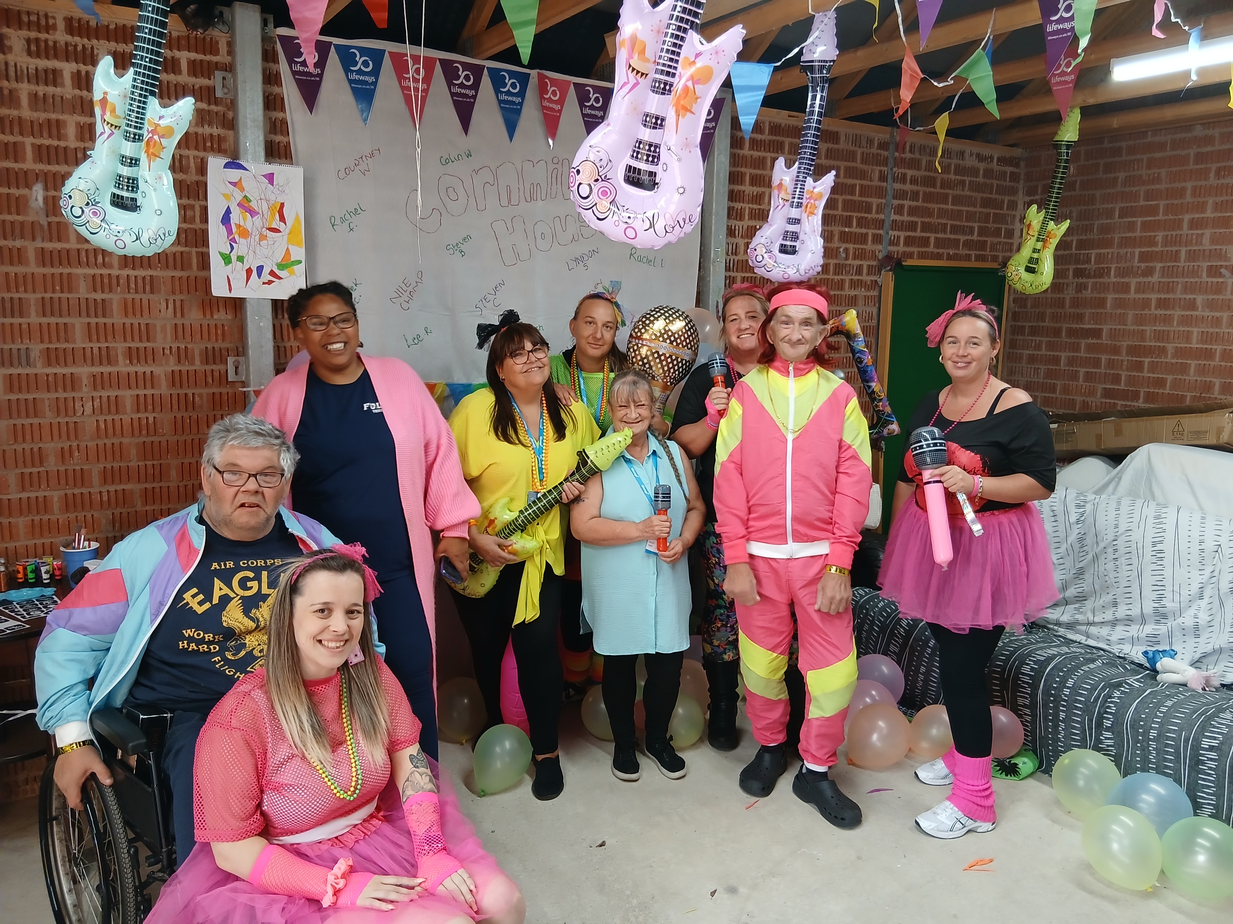 A group of staff and people we support celebrating a birthday party