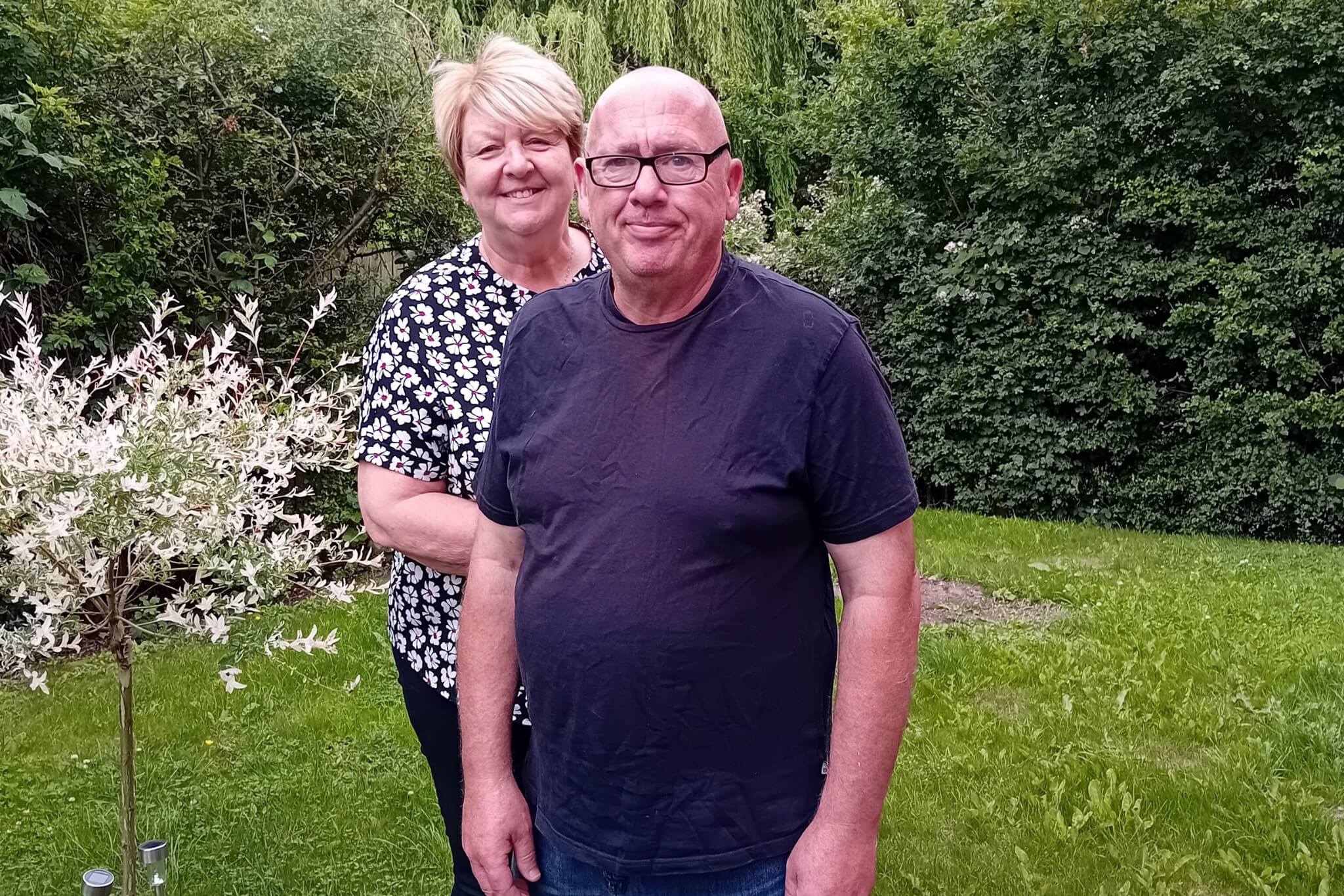 A person we support and their support worker in gardens