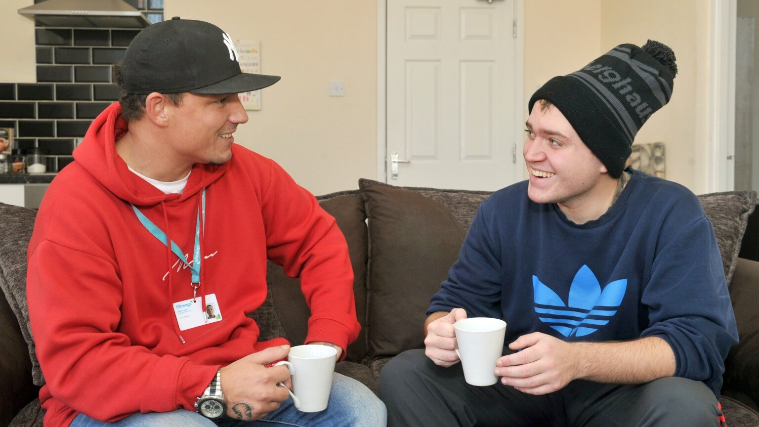 Two men enjoying a hot drink together