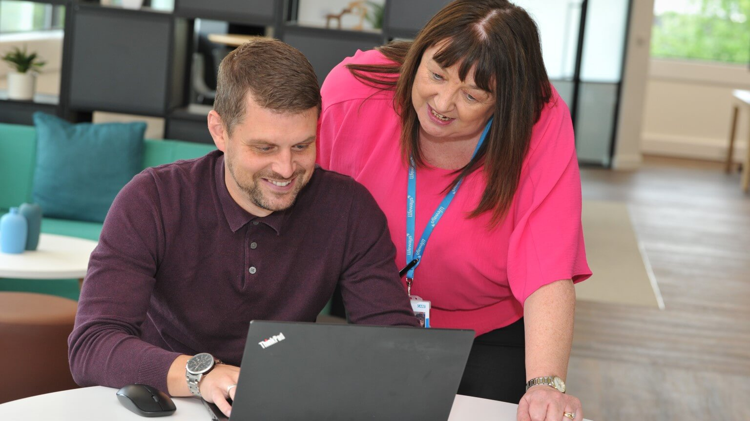 Male and female colleagues reviewing work on a laptop