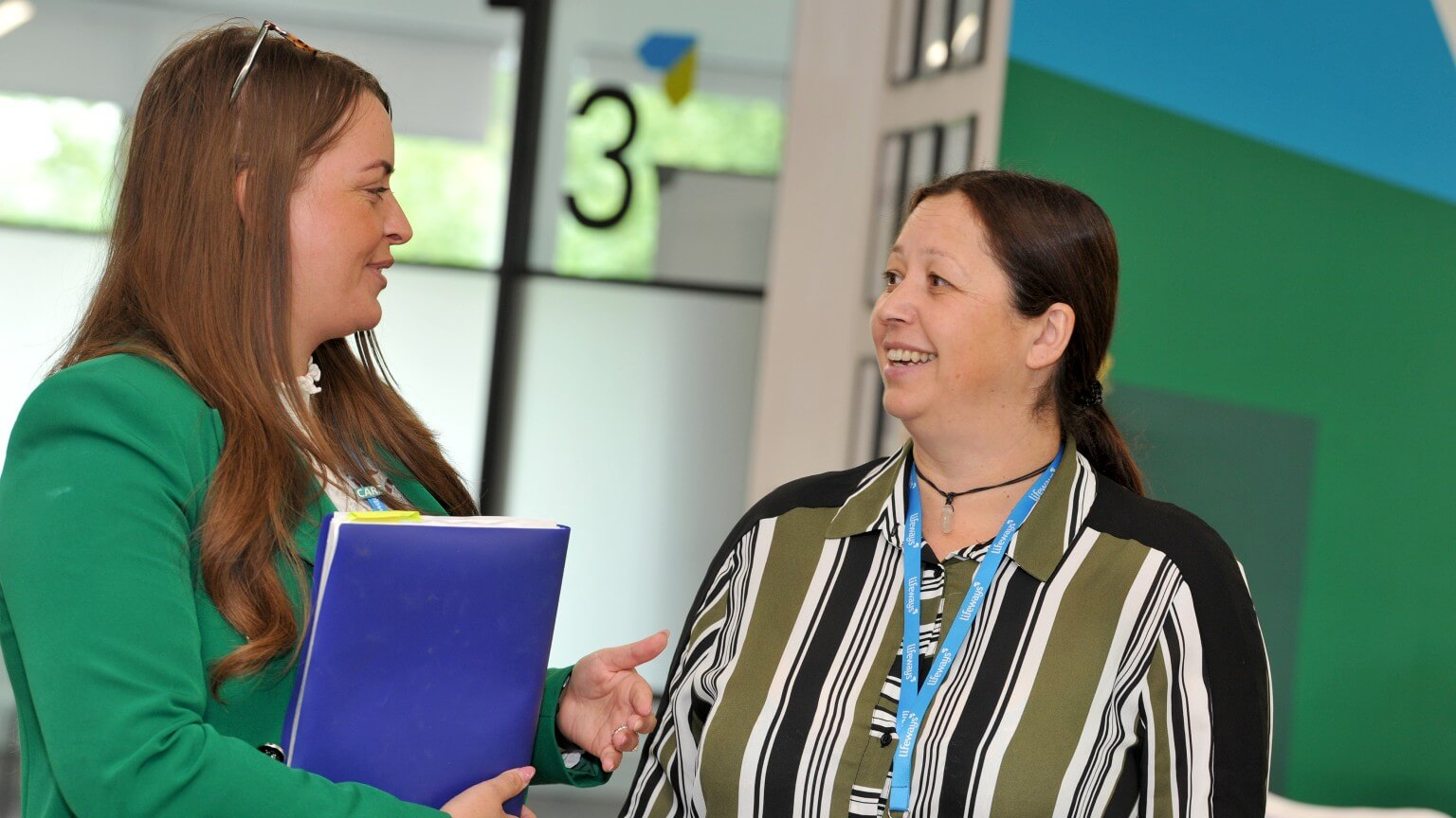 Two team members enjoying a light hearted conversation
