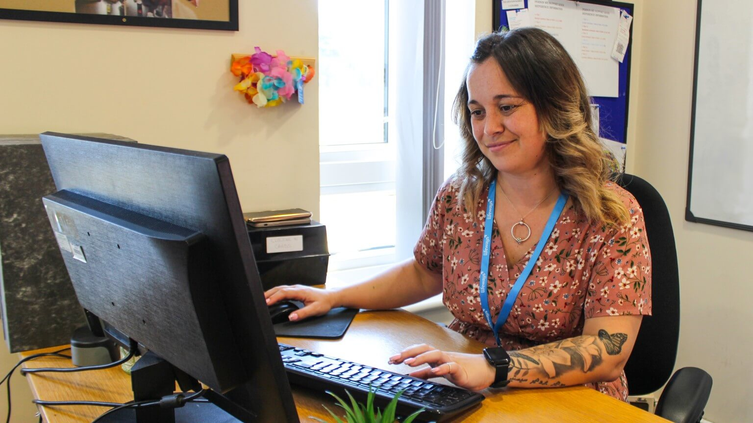 Female service manager using a computer