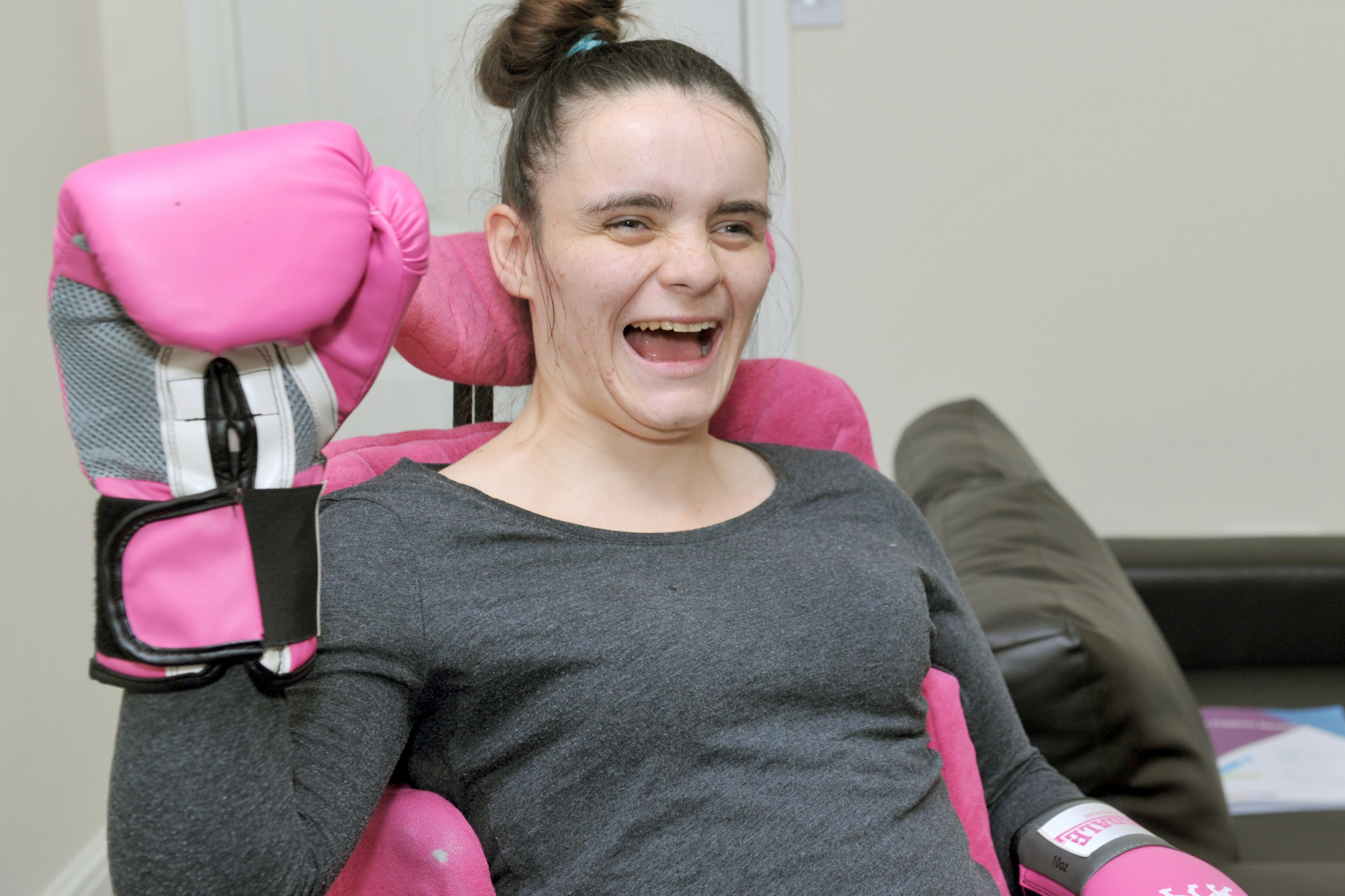 Lifeway’s adult support services resident Alisha wearing a pink boxing glove and smiling 