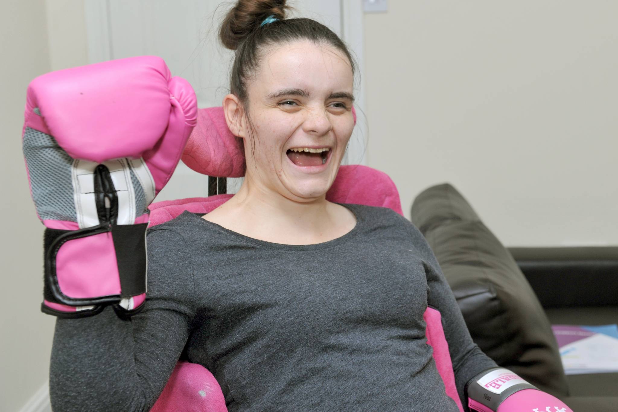 Lifeway’s adult support services resident Alisha wearing a pink boxing glove and smiling 