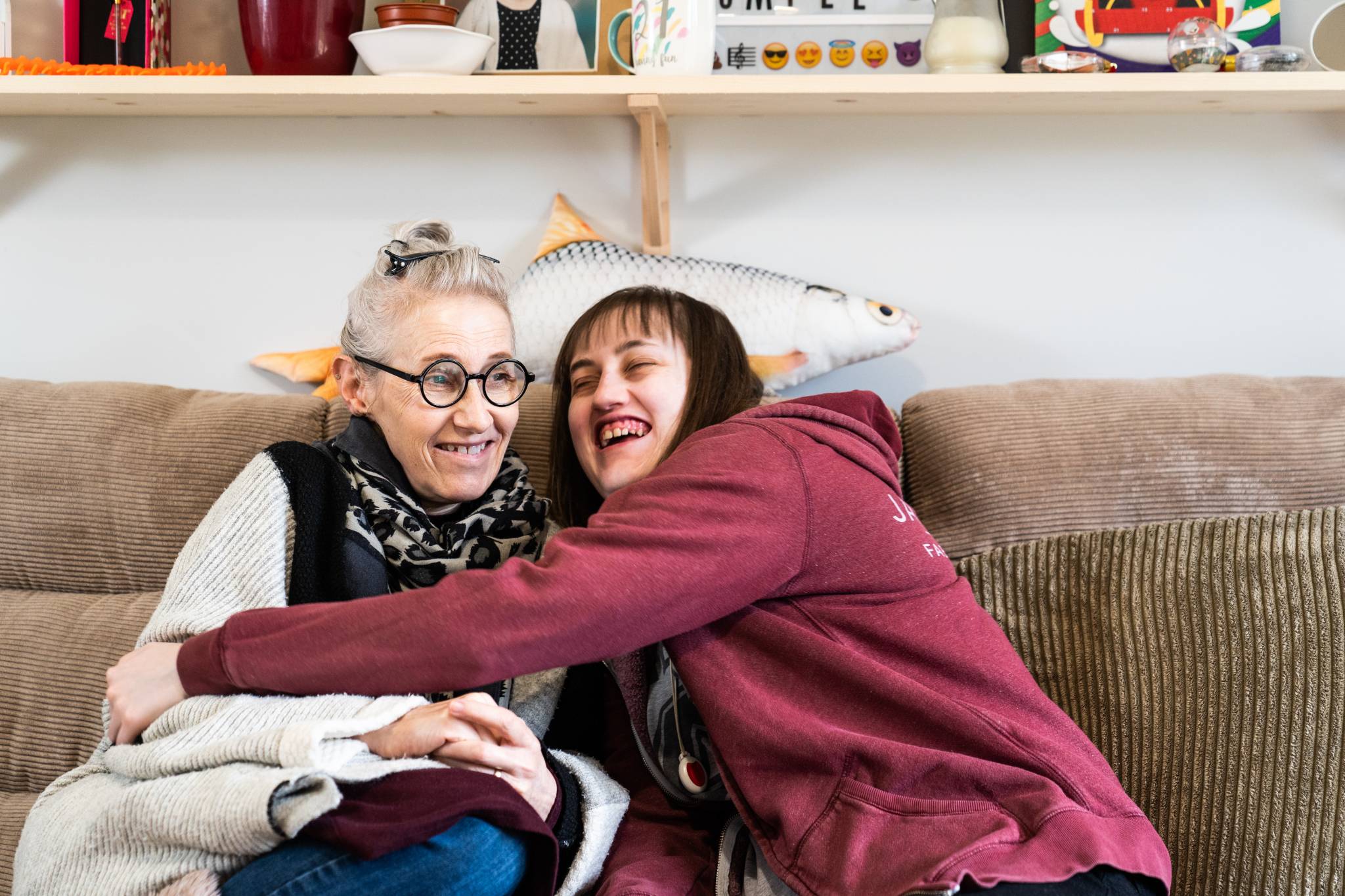two women hugging one another and smiling
