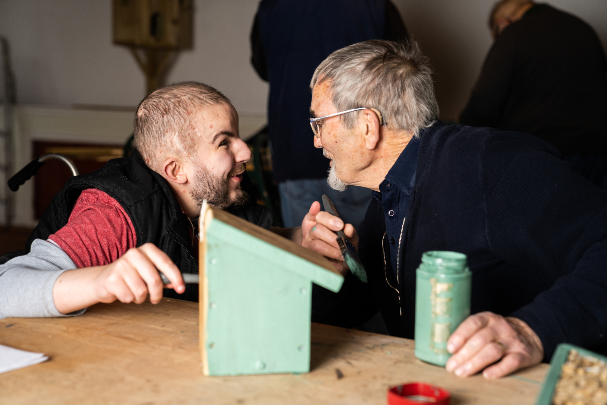 Two people painting and chatting