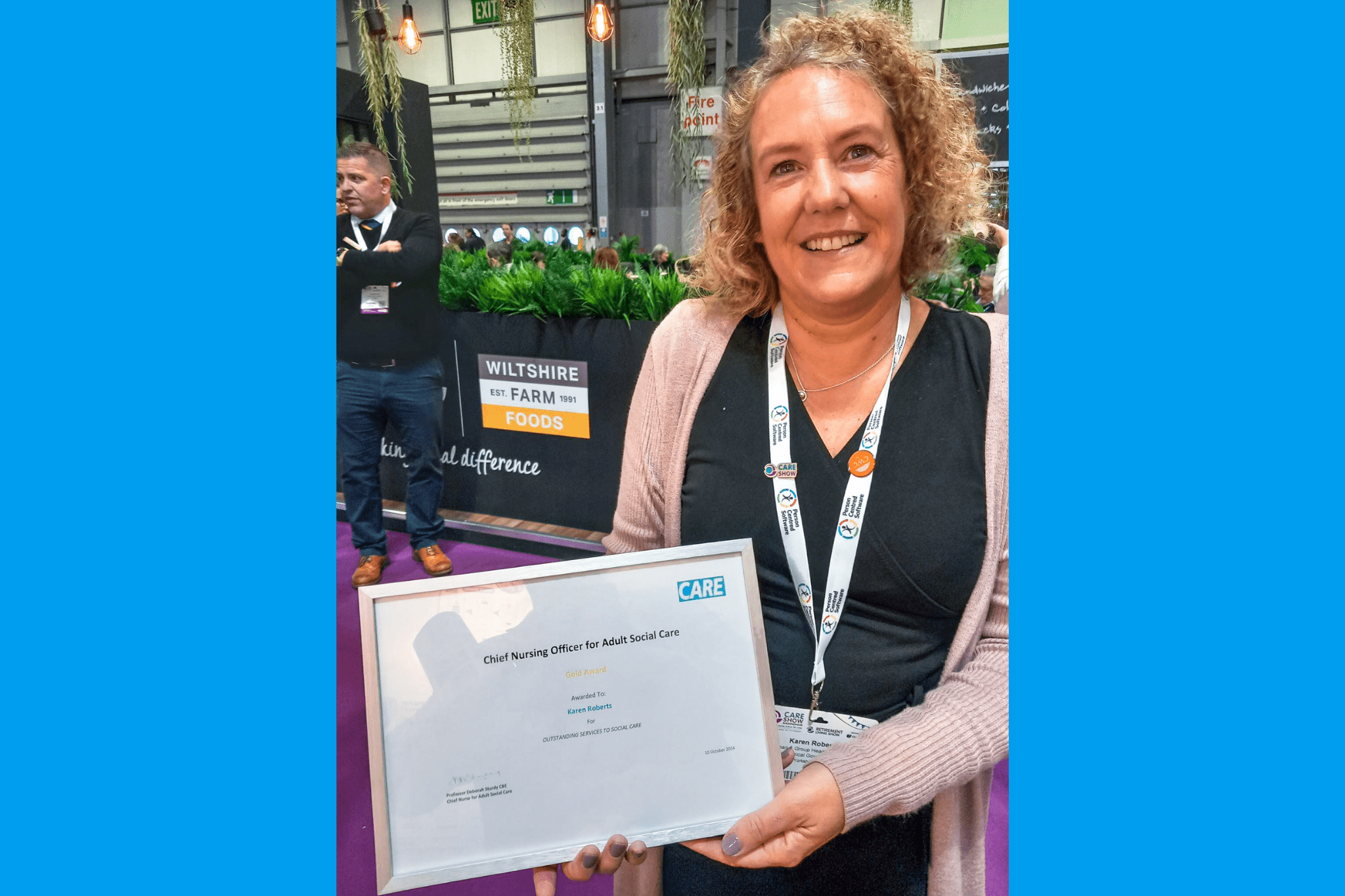 An emotional Karen poses with her award certificate