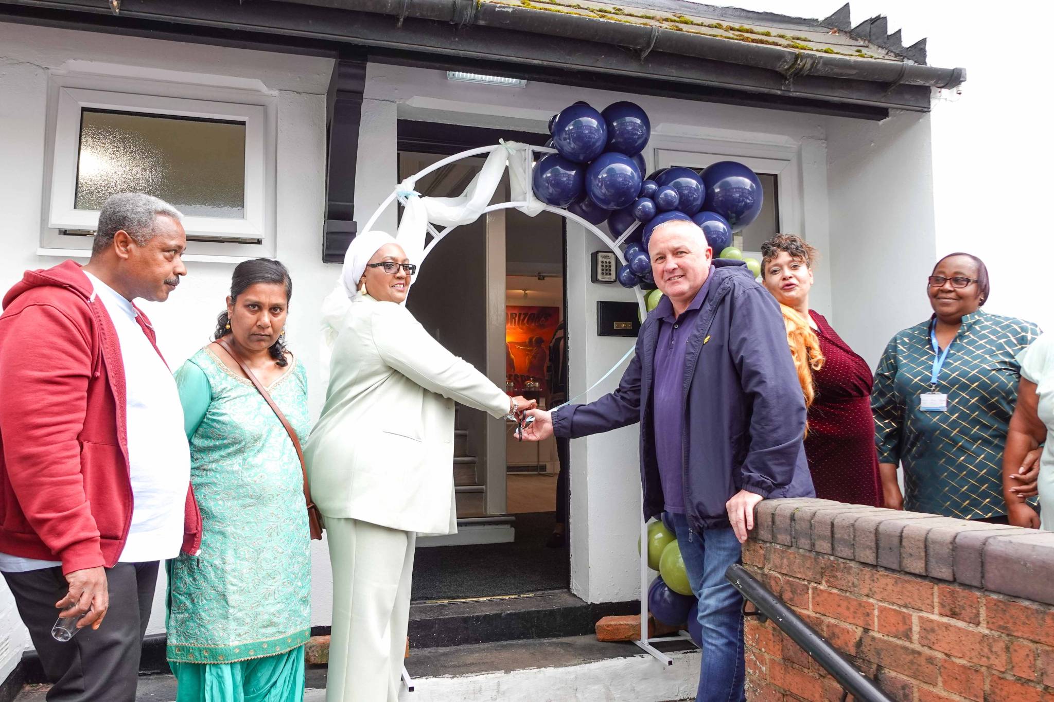 Two people shake hands to officially open the doors to a £500,000 revamp of Beeton Grange