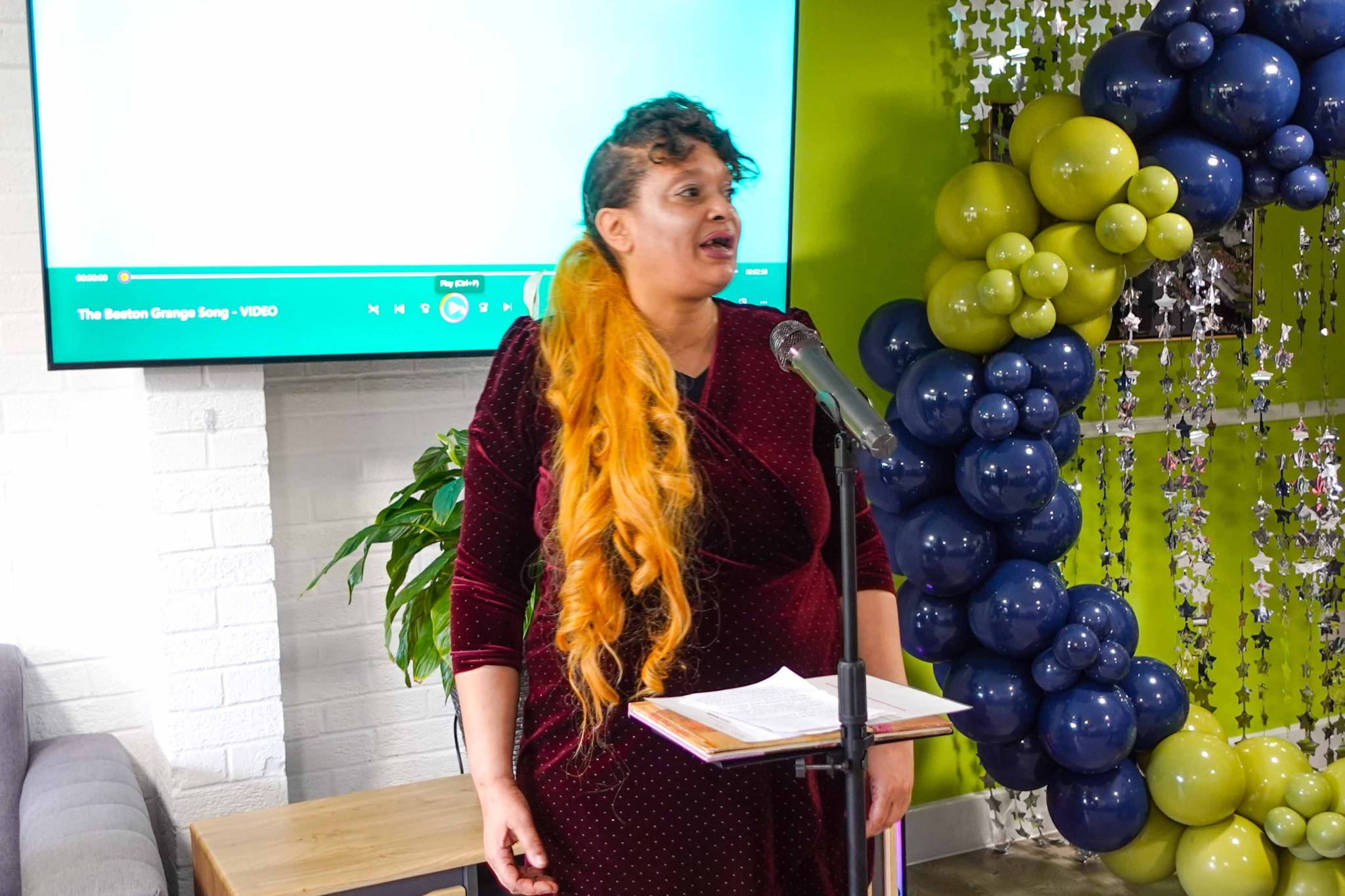 A person we support performs a rap at an open day to launch a newly revamped service