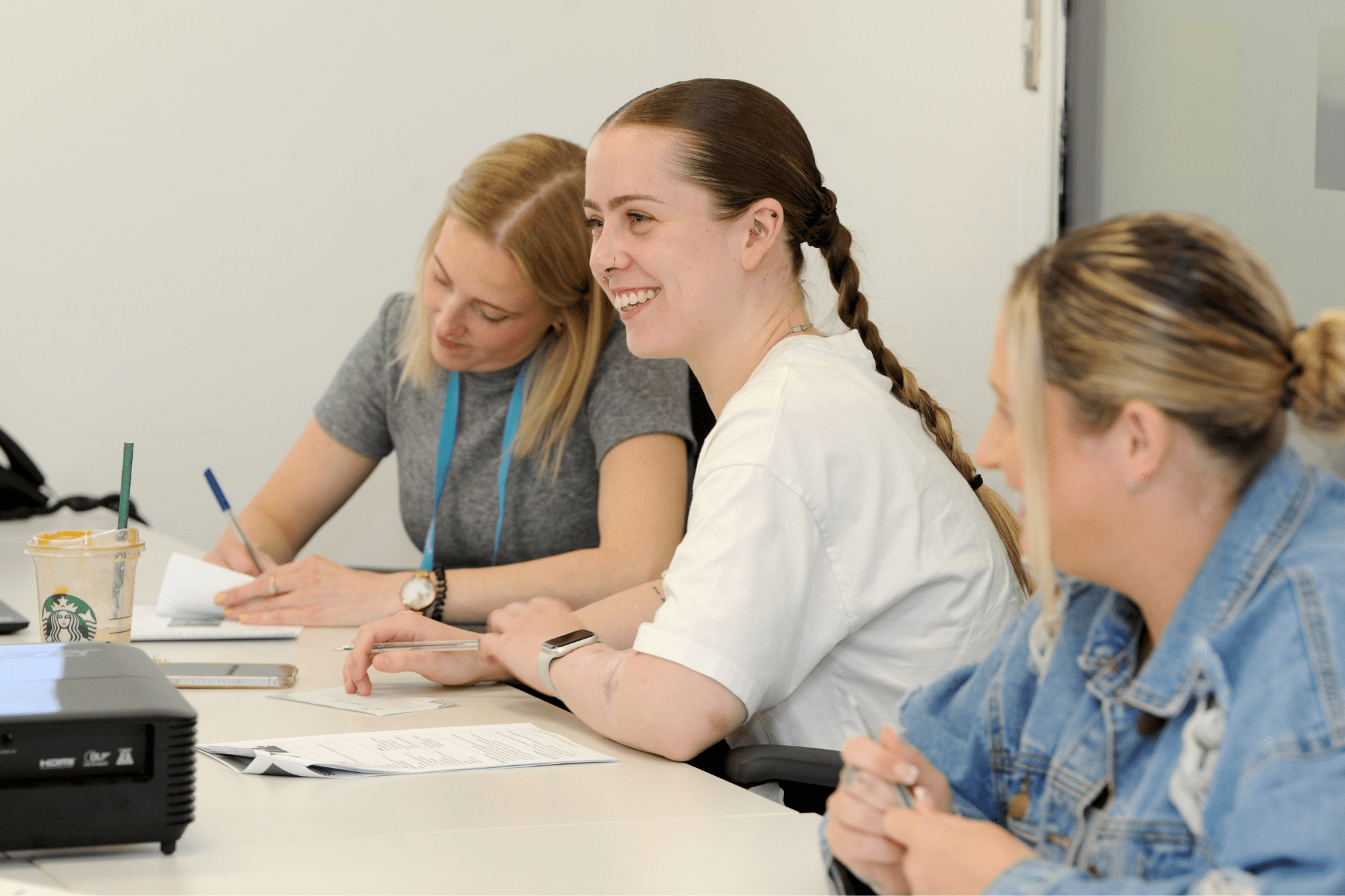 Jess, a smiling person supported by Lifeways, delivering training to support workers