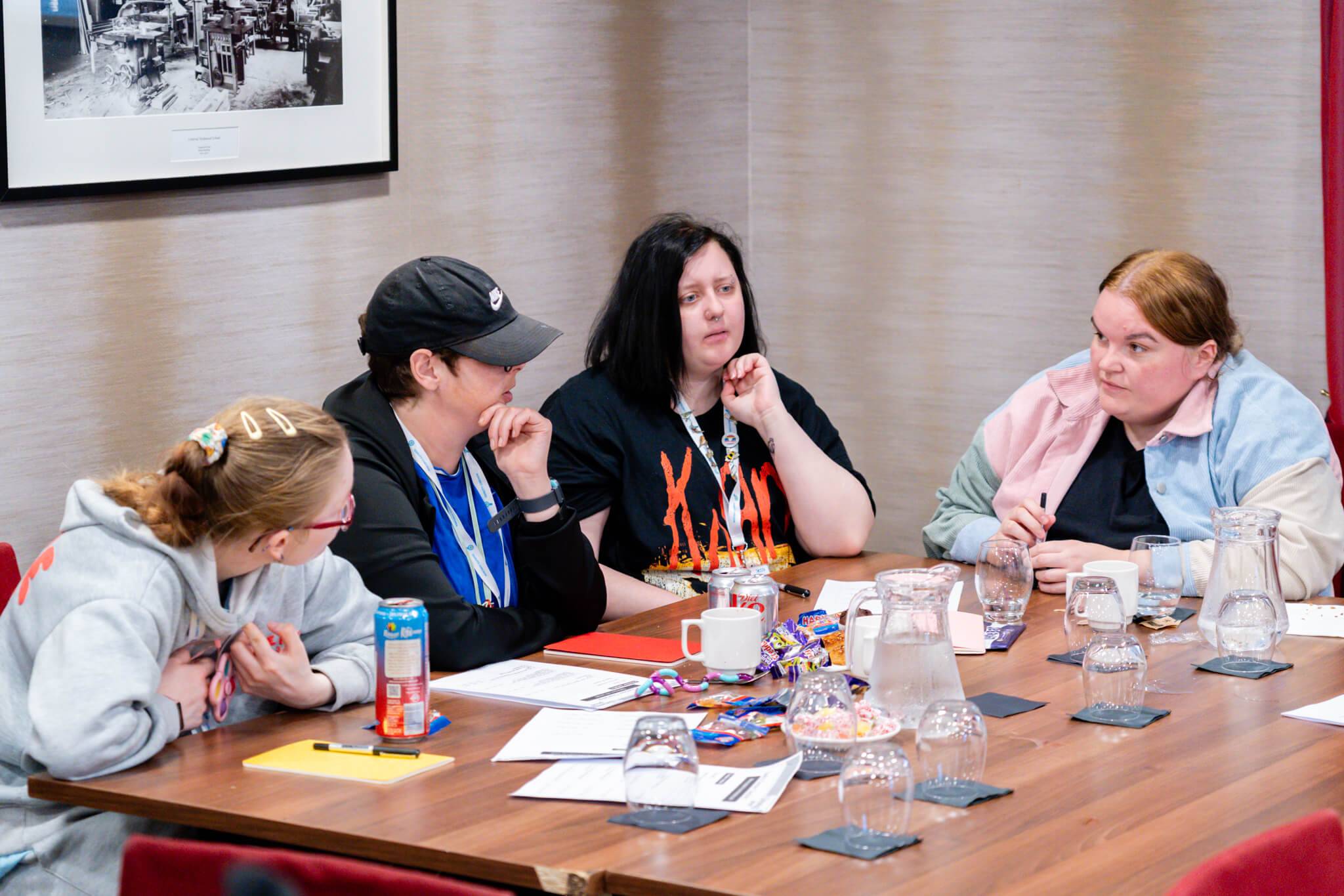 A group of people supported by Lifeways and a support worker at a workshop discussing co-production