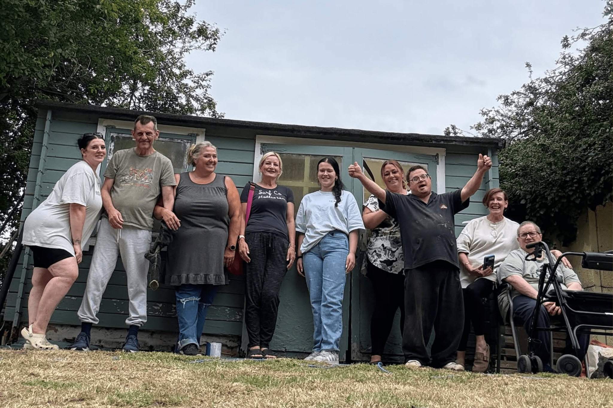 A group of people outside a summerhouse